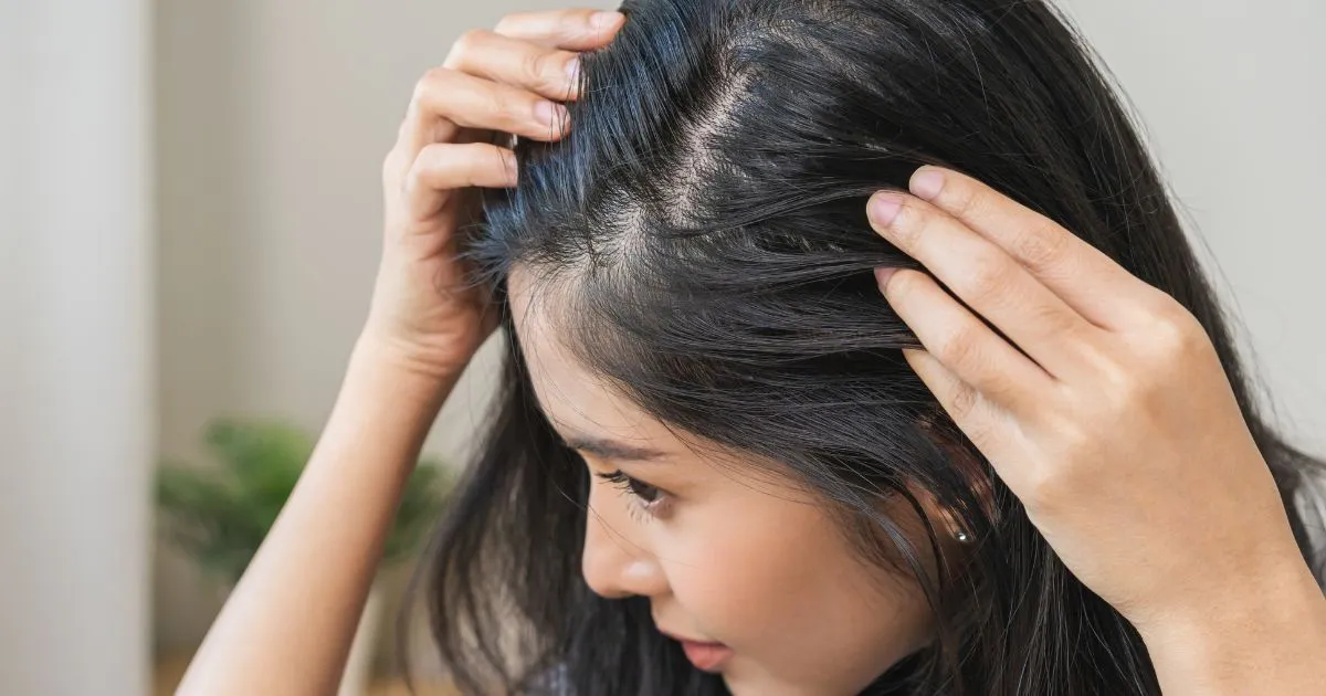 Woman examining scalp for Hair Restoration treatments in Avon, CT